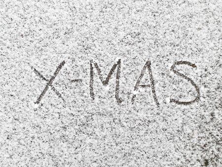 "X-MAS" written in the fresh snow on the streetの写真素材