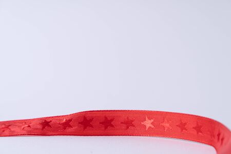 A red ribbon with stars building a frame on white backgroundの写真素材