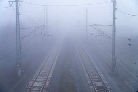 Train tracks in the fog - symmetrical fog imageの写真素材