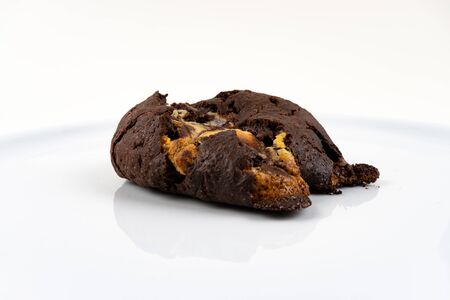 A cookie cake with chocolate on white background with copy space - angled viewの写真素材