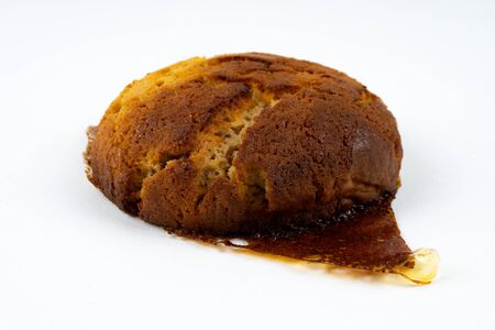 A cookie cake with peanut butter and caramel on white background with copy space - angled viewの写真素材