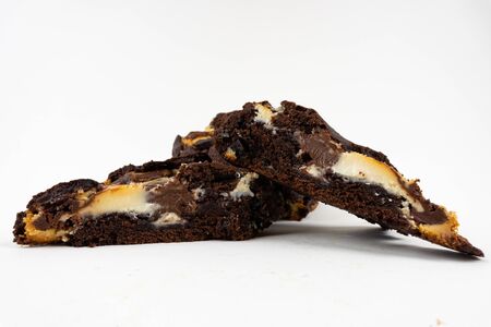 A cut cookie cake with chocolate on white background with copy space - angled viewの写真素材