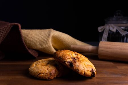 Two delicious cookie cakes with chocolate on a wooden board with copy spaceの写真素材
