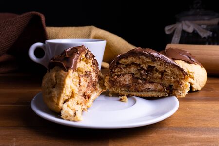 Delicious cookie cakes with chocolate with a cup of coffee on a wooden board with copy spaceの写真素材