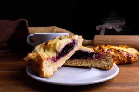 Delicious cheesecake cookie cakes with blueberries and a cup of coffee on a wooden board with copy spaceの写真素材