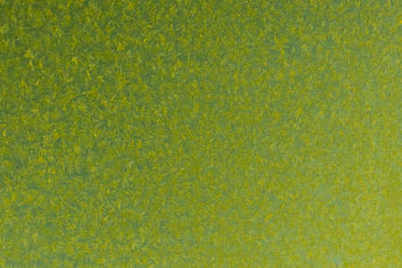 yellow frost on a glass background. texture patterned frosted glass.