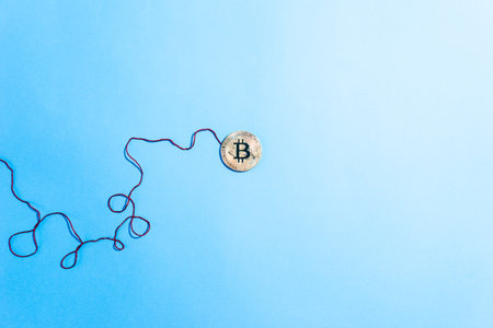 cryptocurrency bitcoin coin on blue background.