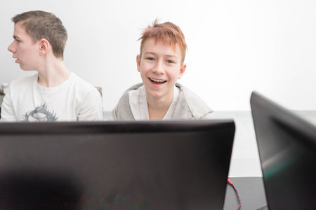 Group teenage boys looking for idea, smile each other. Students work together. A school boy focusing working on laptopの写真素材