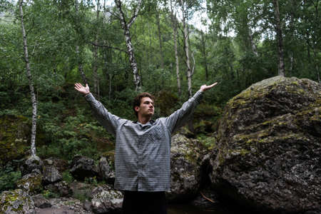 Young man doing yoga in the Park. outdoor yoga exercises.の写真素材