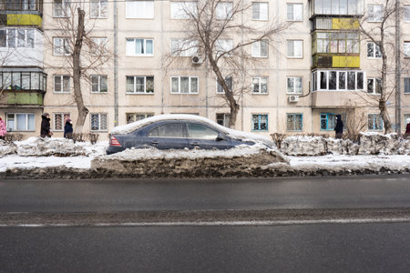 Magnitogorsk, Russia - March 09, 2021: A car abandoned on the side of the road covered with snow. Street of the Soviet Army.のeditorial素材