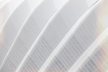 Aluminum discs on  modern building, detail of pattern metal facade for background.
