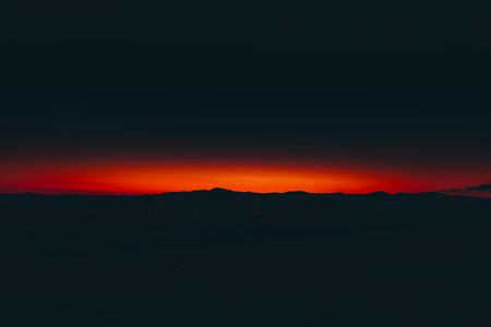 Mountain peaks and clouds at sunrise time.