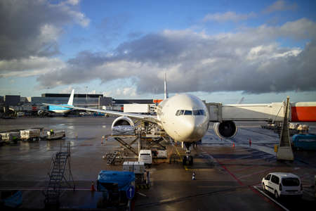 Plane and the airport in the setting sun, Airplane at the terminal gate ready for takeoff.の写真素材