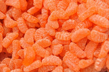A large number of orange candy as a backgroundの写真素材