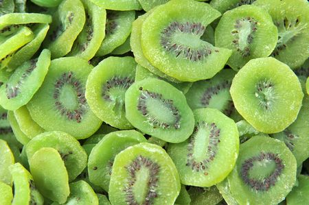 A large number of green kiwi fruit candy as a backgroundの写真素材