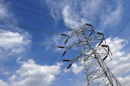 Power tower standing in the blue sky and white cloudsの写真素材