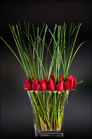 Red roses in a glass vaseの写真素材