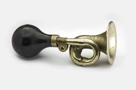 Vintage brass bicycle horn on white backgroundの写真素材