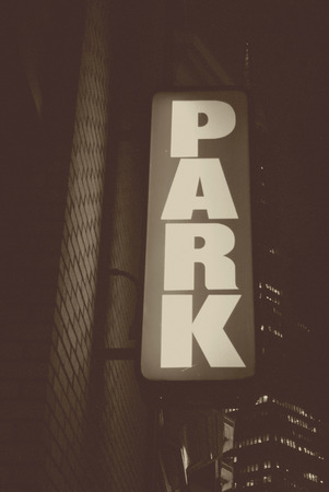 Parking signage on a parking garage in a cityの写真素材