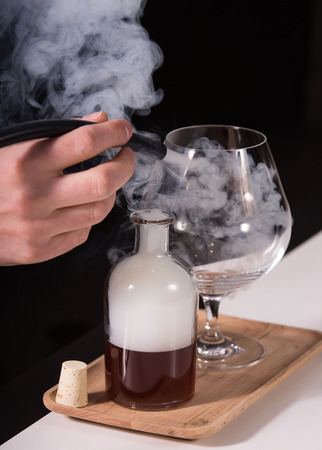 Smoked cocktail on wood platterの写真素材