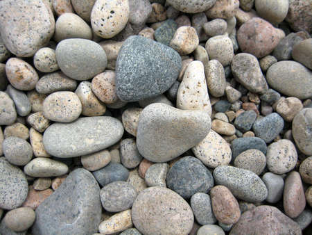 Smooth rocks on ocean beach for a background.