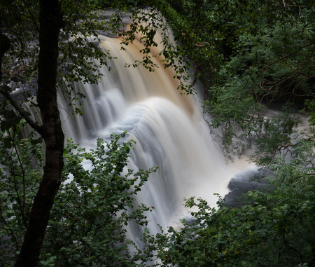 Huge ledged waterfall on the Mellte river, near Pontneddfechan in South Wales, UK.の写真素材