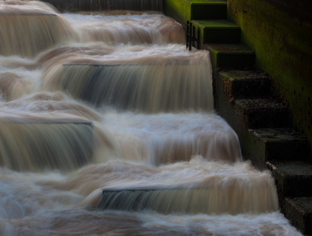 A fish ladder, AKA a fishway, fish pass or fish steps, is a structure around artificial and natural barriers to allow fish to continue migration.の写真素材