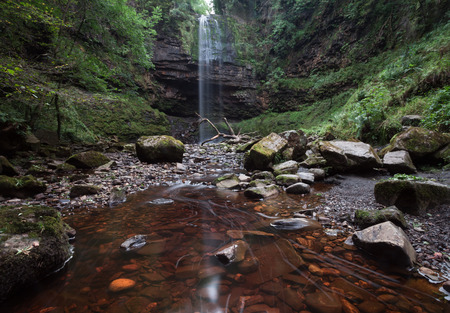 Henrhyd Falls, the highest waterfall in South Wales featured as the Batcave in the film 'The Dark Knight Rises'の写真素材