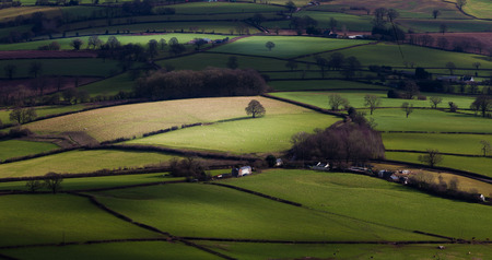The lush green countryside below the Skirrid and Sugar Loaf mountains in South Walesの写真素材