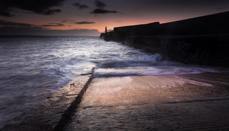 Sunrise at Porthcawl lighthouse in South Glamorgan, South Walesの写真素材