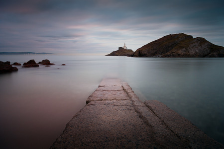 Mumbles Beach and Lighthouse The old concrete slipway at Mumbles beach and lighthouseの写真素材