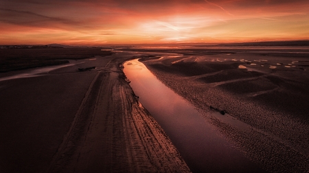Sunset at low tide on the Loughor Estuary, Penclawdd, North Gower, Swansea, UKの写真素材