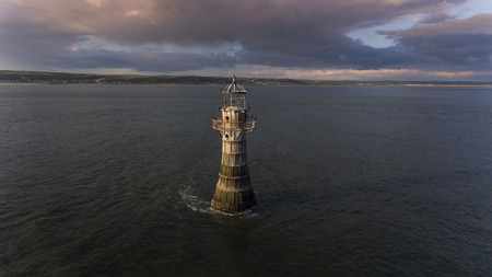 Cormorants perched on Whiteford lighthouse, an unusual cast iron lighthouse built in 1865 to mark the shoals of Whiteford Point, the only wave swept cast iron tower of this size in Britainの写真素材