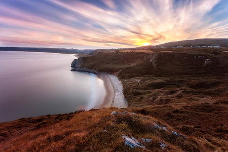 Editorial Swansea, UK - July 24, 2017: Sunset over Tor Bay and Penmaen village on the Gower peninsula in Swansea, UK's first designated Area of Outstanding Natural Beauty, South Wales, UKのeditorial素材