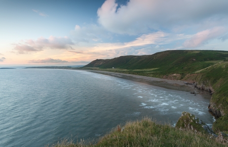 Editorial Swansea, UK - July 23, 2017: Rhossili Bay at the far tip of the Gower peninsula, showing The Old Rectory, possibly the most photographed house in Wales, UKの写真素材