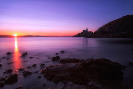 A calm morning at Mumbles lighthouse in Swansea, South Wales, UKの写真素材