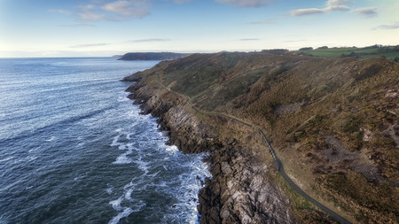 Wales Coastal Path, a long-distance footpath which runs along the majority of the coastline of Wales seen here as it stretches from Langland Bay towards Caswell Bayの写真素材