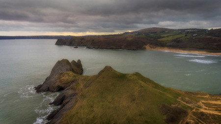 Full tide at Three Cliffs Bay and the Great Tor on the Gower peninsula in Swansea, South Wales, UK