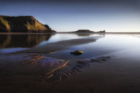 Blue hour at Worms Head on the Gower peninsula in Swansea, South Wales, UKの写真素材