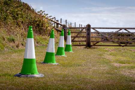 Green safety cones produced and placed to indicate access to a lane for driversの写真素材