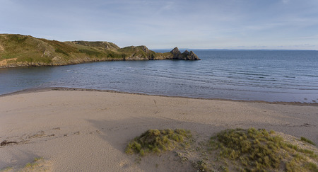 The beach at the dramatic Three Cliffs Bay on the Gower peninsula, Swansea, South Wales, UK