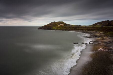 Crashing waves on the coast at Bracelet Bay on the Gower peninsula in Swansea, South Wales, UKの写真素材
