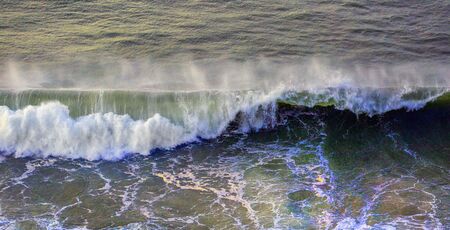 Waves breaking on the coast of the Gower peninsula in Swansea, South Wales, UKの写真素材