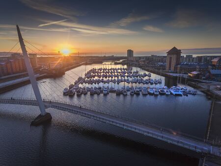 Editorial Swansea, UK - January 21, 2020: Sunrise at Swansea Sail Bridge on the River Tawe at the marina in Swansea, UKのeditorial素材