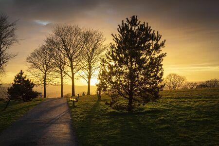 Sunset and a bench at Ravenhill park in Swansea, South Wales, UKの写真素材