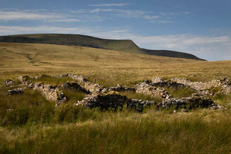 The summit of Moel Feity and the remains of an old farmhouse near the source of the river Tawe in...