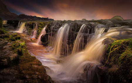 A combo photo of a waterfall in South Wales UK and a sky from the Gower peninsulaの写真素材
