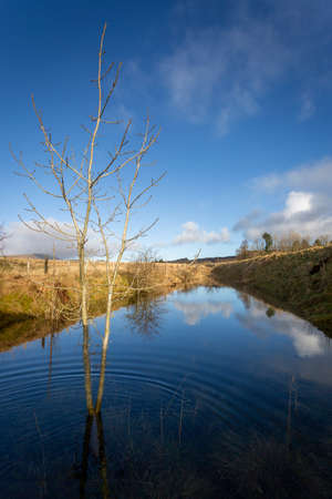 The old railway track at Penwyllt in the Brecon Beacons UK flooded after heavy rainfallの写真素材
