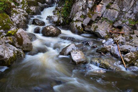 The Pwll y berw river after heavy rainfall at Dinas rock in the neath valley, South Wales UK