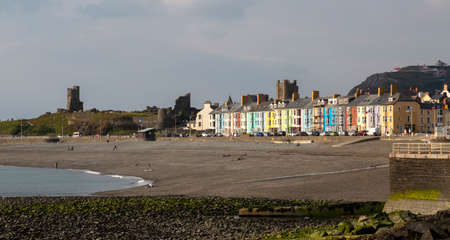 Editorial Aberystwyth, UK - June 27, 2021: South Beach in Aberystwyth showing the colourful houses and the remains of the old castleのeditorial素材